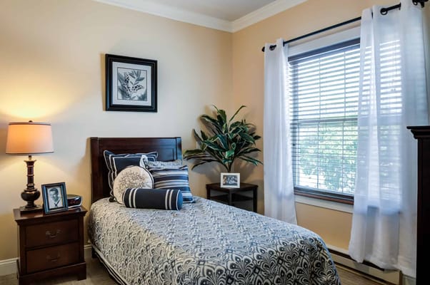 Cozy private resident room with bed and decor