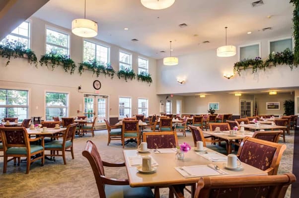 Bright dining room with tables set for meals