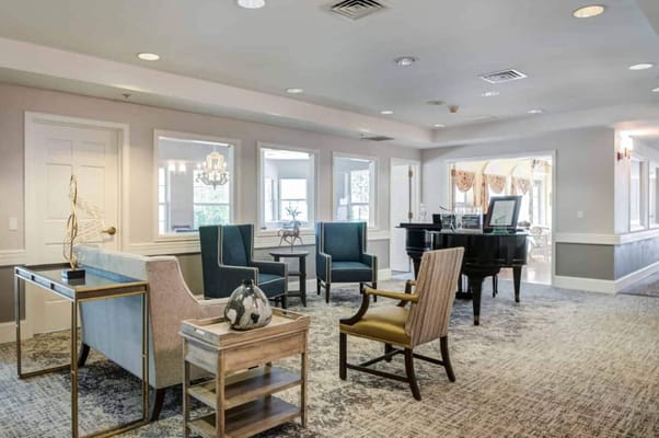 Bright common area with seating and a piano