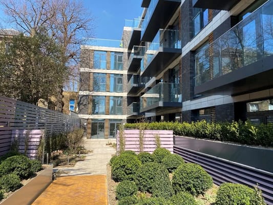 Exterior view of a modern assisted living facility with landscaped garden