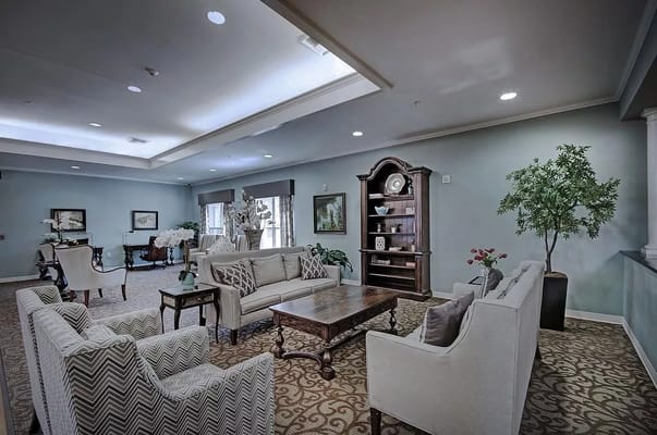 A cozy living room with comfortable seating and decorative plants.