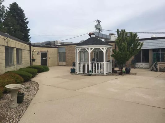 Outdoor courtyard with gazebo and landscaped gardens