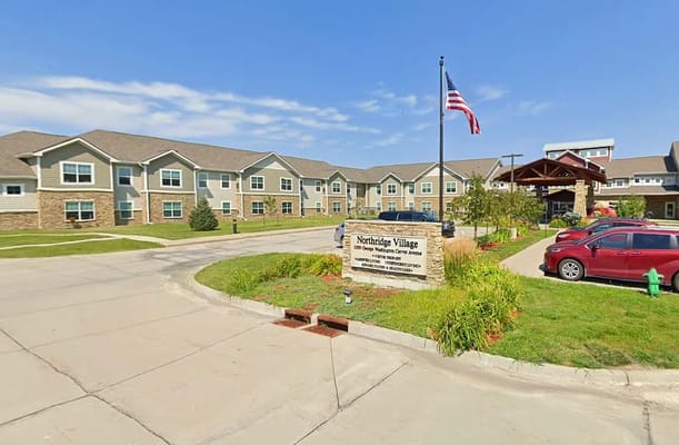 Exterior view of Northridge Village with flag and sign
