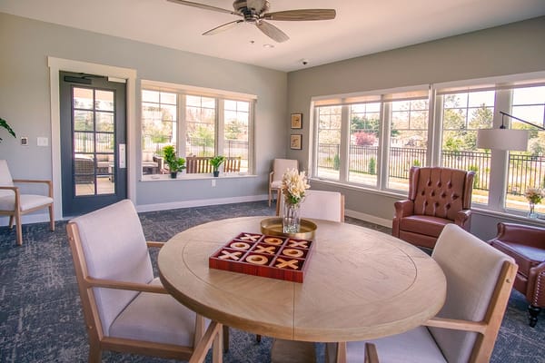 Bright common area with seating and large windows