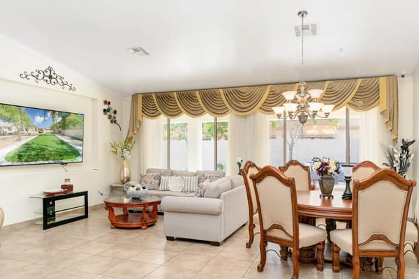 Cozy living room with a sofa, dining area, and a large TV