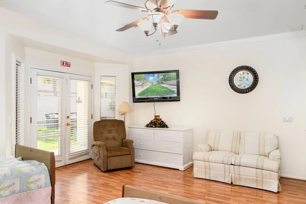 Lounge area with a comfortable chair and a TV