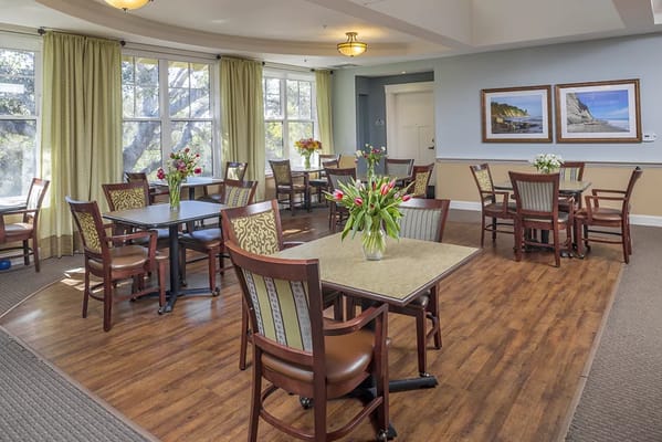Bright dining room with tables and flowers