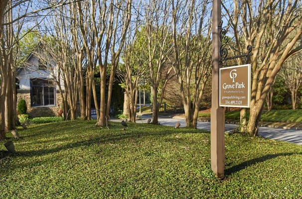 Entrance sign of Grove Park surrounded by trees