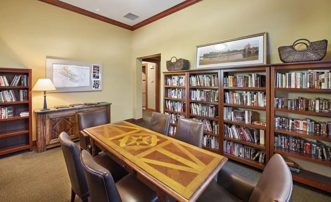 Common area with bookshelves and a large table