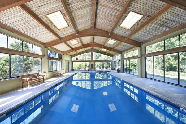 Indoor swimming pool area with large windows