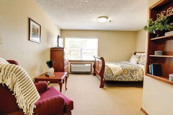 Cozy private resident room with a bed and a chair