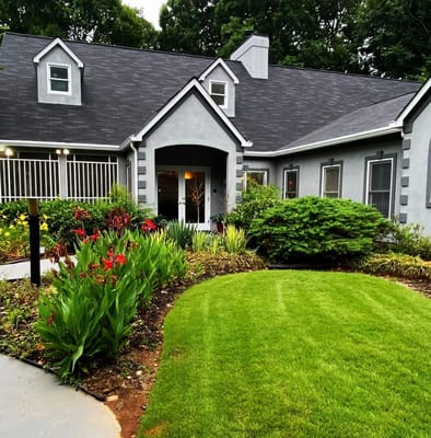 Well-maintained exterior view of Oak Leaf Manor with gardens