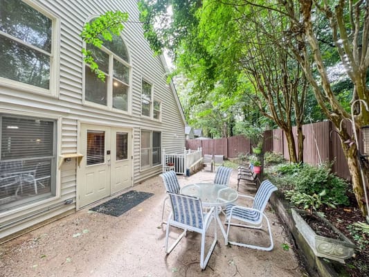 Outdoor patio area with seating and greenery