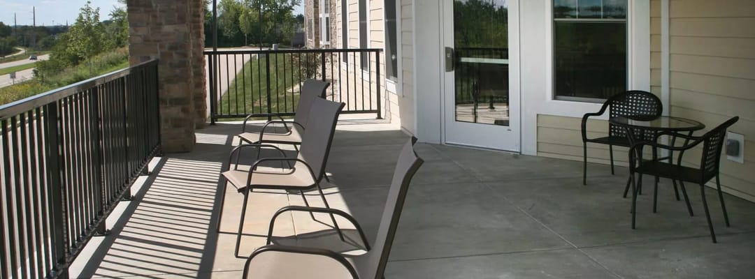 Outdoor balcony area with seating