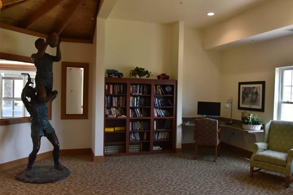 Interior view of a common area with bookshelves and seating
