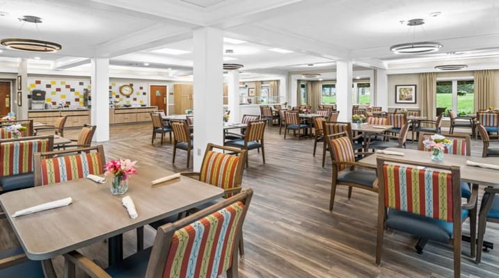 Bright dining area with colorful chairs and tables in Oakleaf Village.