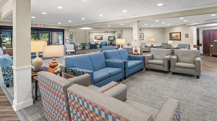 Cozy living room with seating areas and lamps