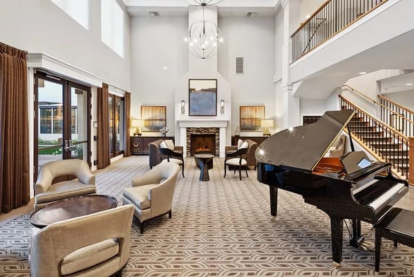 Bright common area with seating and a piano