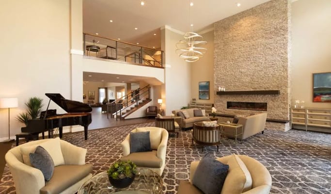 Spacious lobby with seating and a grand piano at Oakmont of Orange