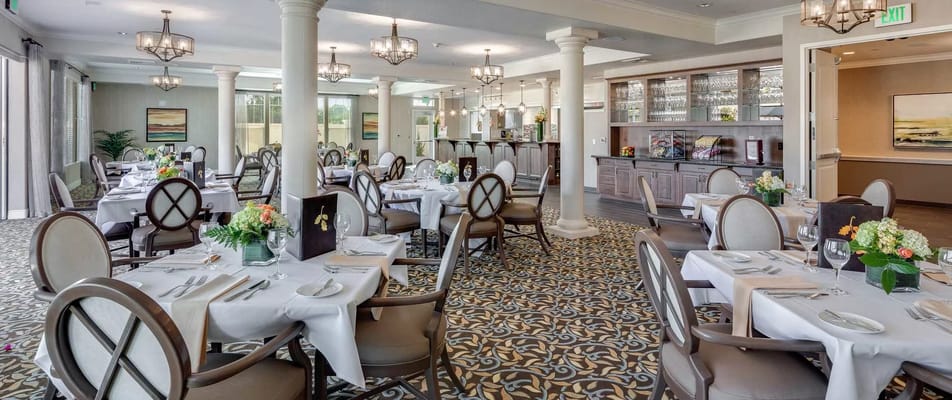 Elegant dining room setup with tables and flowers