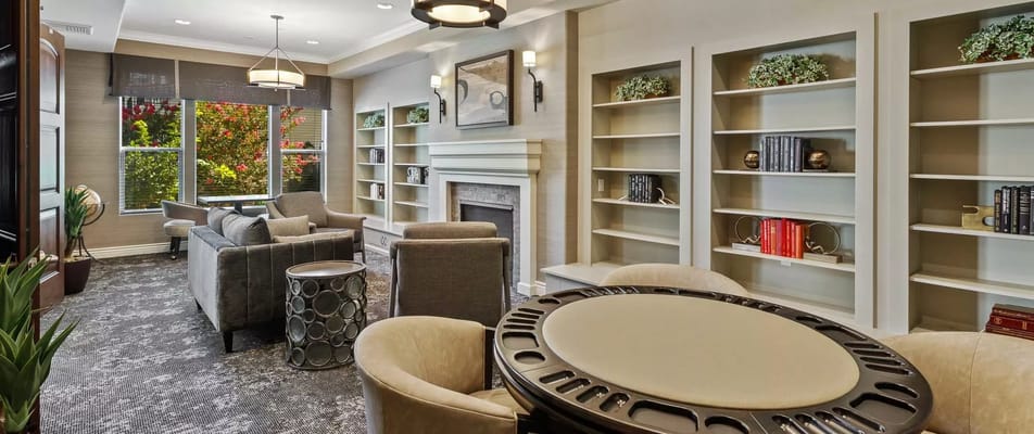 Comfortable common area with seating and bookshelves