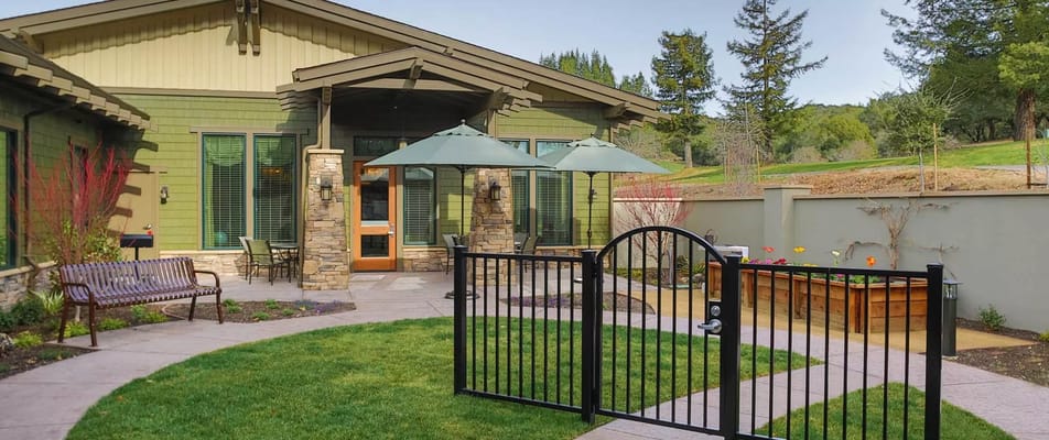 Outdoor patio area with greenery and seating at Oakmont of the Terraces