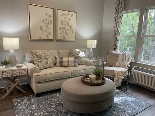 Cozy living room area with a sofa and natural light