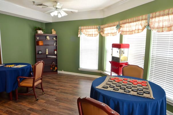 Bright common area with tables and games
