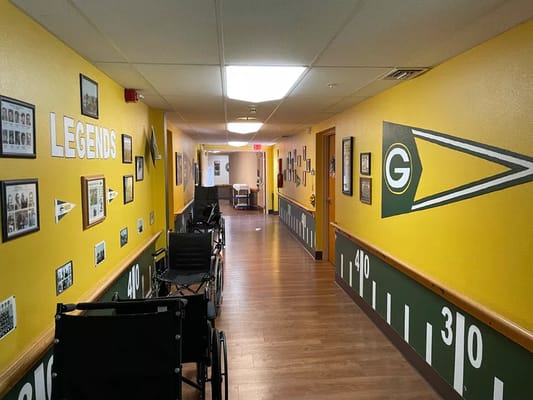 Brightly colored hallway with resident photos and vintage sports theme