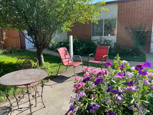 Outdoor seating area with flowers and shade