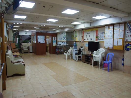A spacious common area with seating and information boards