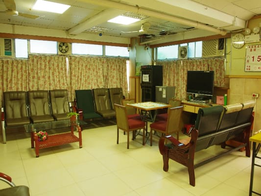 Spacious common area with seating and a television.
