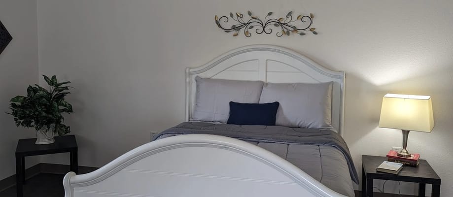 Cozy bedroom setup with a bed, lamp, and decoration