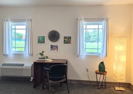 Cozy resident room with desk and artwork