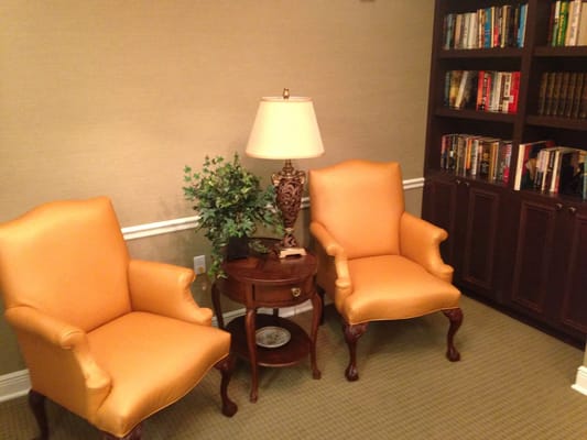 Cozy seating area with orange chairs and a lamp