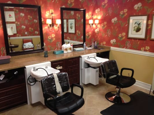 A salon area with sinks and styling chairs