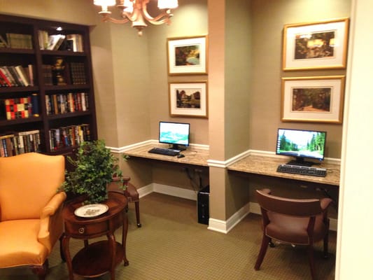 Cozy reading nook with computers in a common area