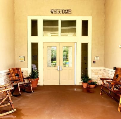 Entrance with double doors and rocking chairs
