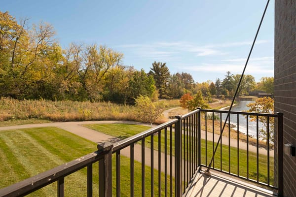 View from a balcony overlooking landscaped grounds and water