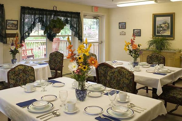Well-set dining room with floral arrangements and tableware