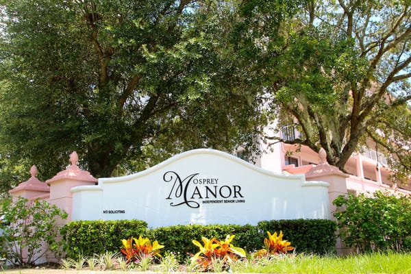 Exterior view of Osprey Manor sign and landscaping