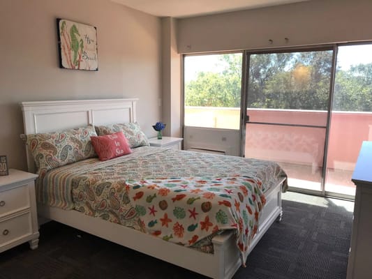 Bright private bedroom with a bed and large window