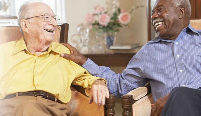 Two senior residents laughing and enjoying each other's company