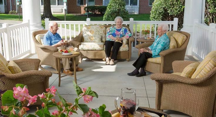 Residents enjoying time on a patio with drinks