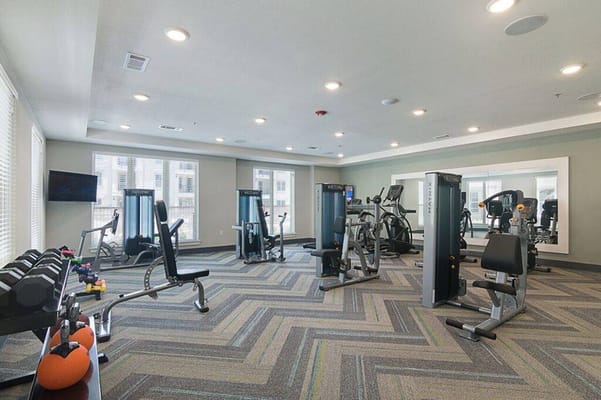 A well-equipped fitness room with gym equipment