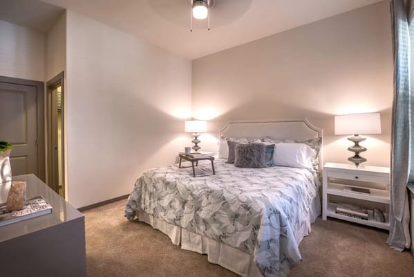 Stylish bedroom with a bed, lamp, and nightstand