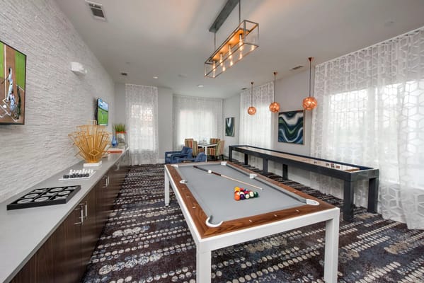 Bright activity room with game tables and decor