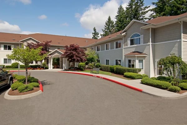 Entrance view of Patriots Glen Assisted Living with landscaped surroundings.