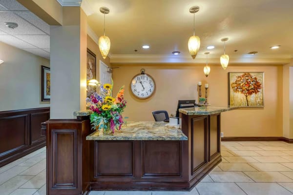 Reception area with flower arrangement and clock