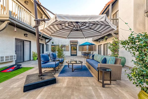 Outdoor seating area with sunshade and comfortable furniture